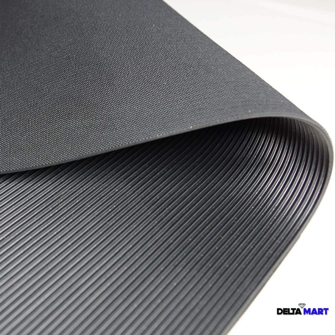 Rolled black ribbed mat partially unrolled, showing textured top surface and grooved underside; DeltaMart logo in corner.