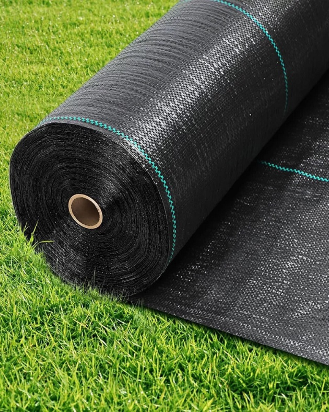 Roll of black landscape fabric on green grass, with a exposed cardboard core at the center.