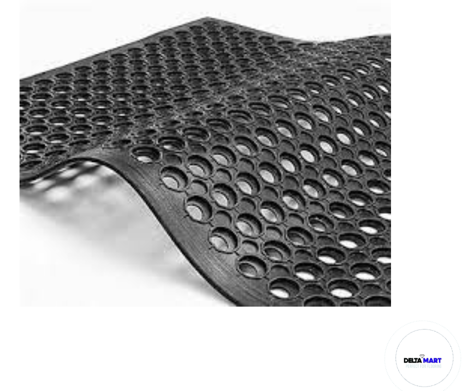 Black perforated rubber floor mat with circular holes and a curved edge visible