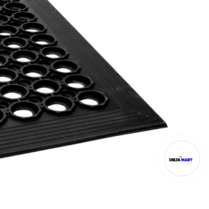 Close-up of a black rubber mat with circular hole pattern and a Delta Mart logo in the corner.