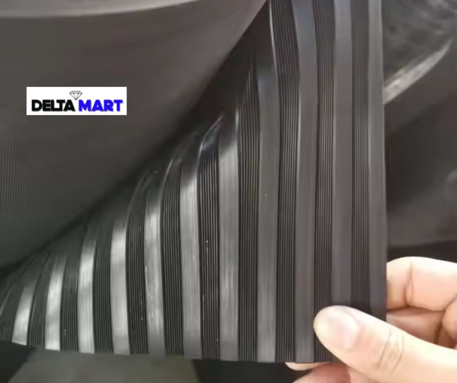 Close-up of a stack of black ribbed belts being held by a hand; Delta Mart logo visible in the corner (informative image)
