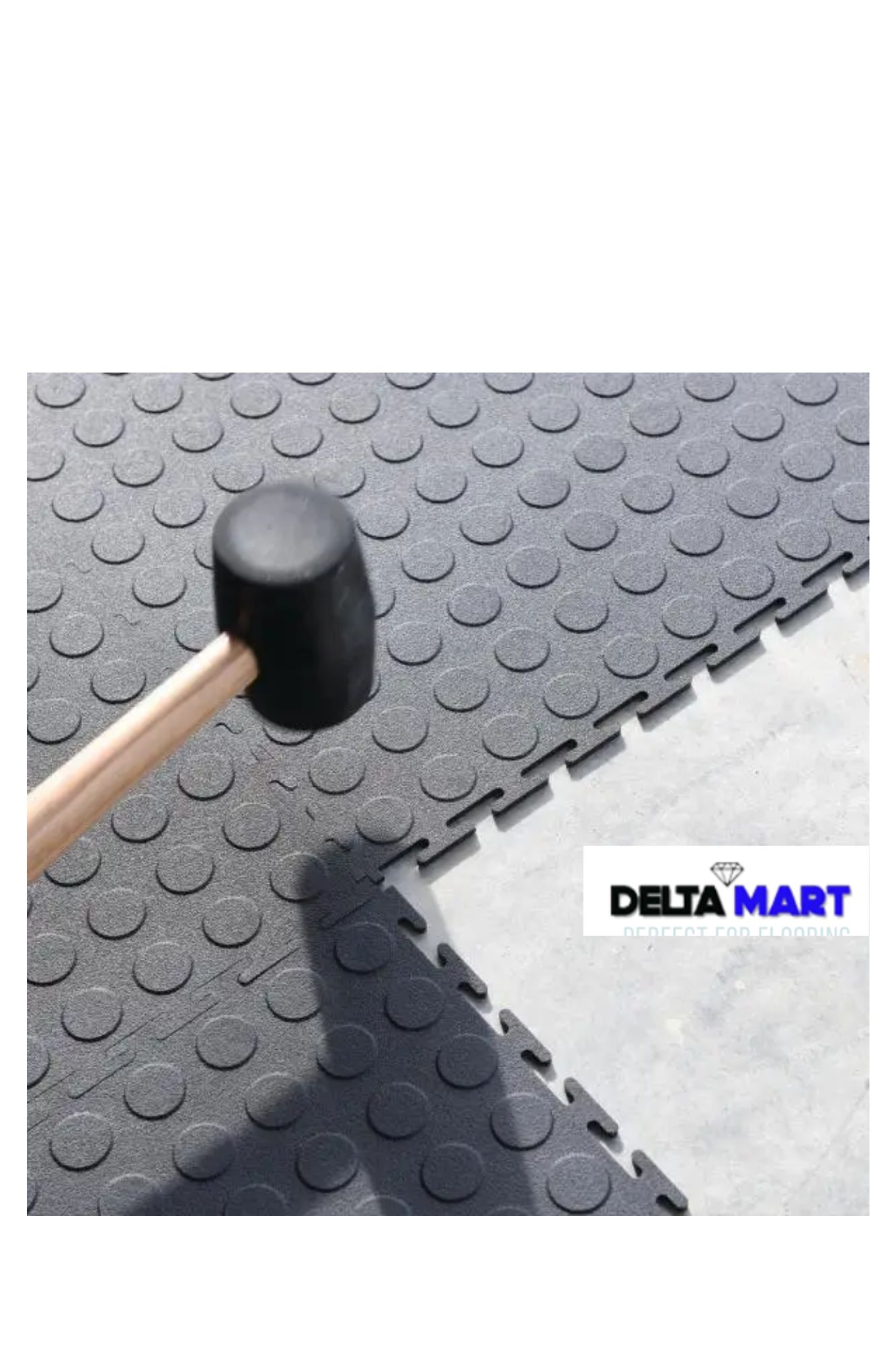 Rubber mallet resting on gray interlocking floor tiles, with a Delta Mart logo visible in the corner.