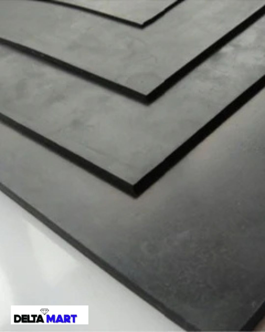 Close-up of overlapping metal stair treads with dark edges, showing a stepped pattern; Delta Mart logo at the bottom-left corner.