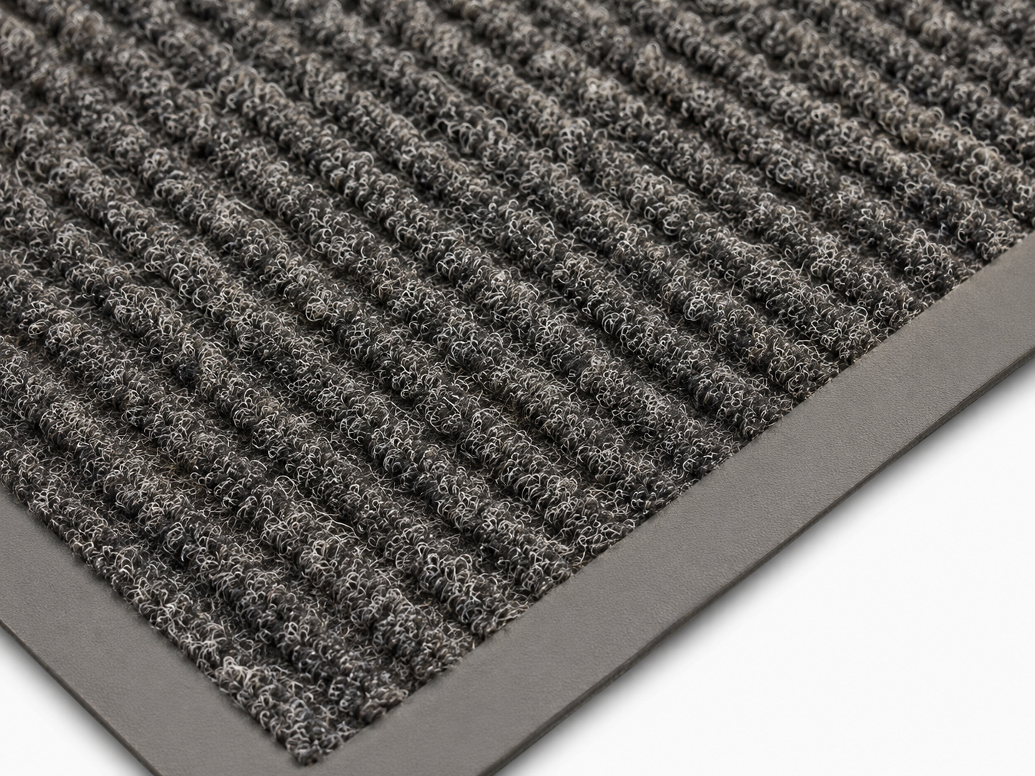 Close-up of a gray looped-pile doormat with a rubber edge, showing dense fiber texture.