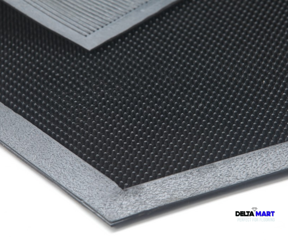 Close-up of a black anti-slip floor mat with a gray border; Delta Mart logo in the bottom-right corner.